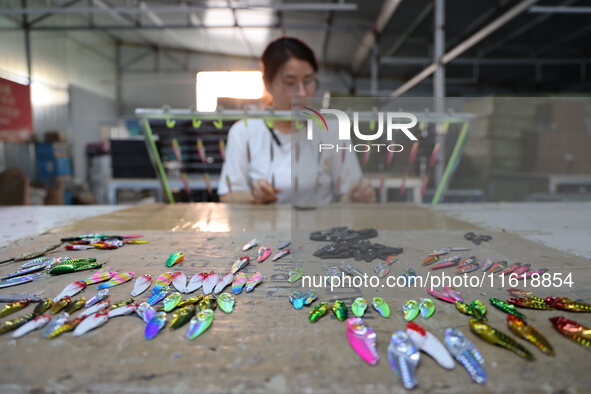 A worker works in a workshop of a fishing tackle company in Binzhou, China, on September 29, 2024. 