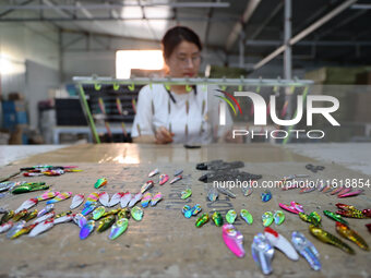 A worker works in a workshop of a fishing tackle company in Binzhou, China, on September 29, 2024. (