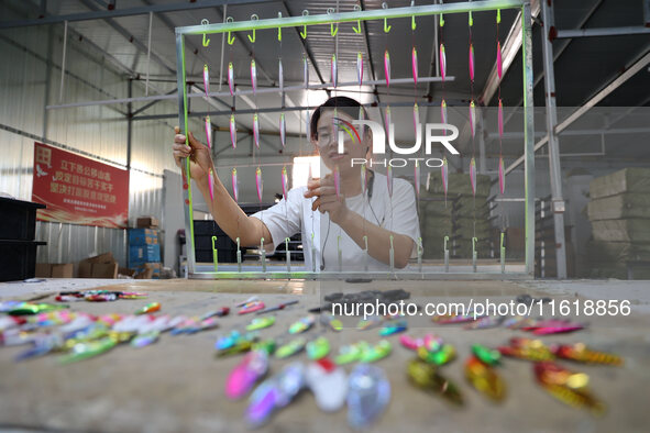 A worker works in a workshop of a fishing tackle company in Binzhou, China, on September 29, 2024. 