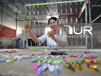 A worker works in a workshop of a fishing tackle company in Binzhou, China, on September 29, 2024. (