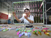 A worker works in a workshop of a fishing tackle company in Binzhou, China, on September 29, 2024. (