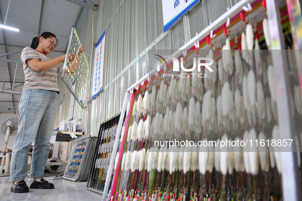 A worker works in a workshop of a fishing tackle company in Binzhou, China, on September 29, 2024. 