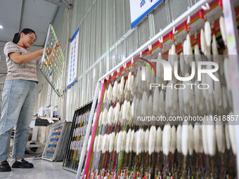 A worker works in a workshop of a fishing tackle company in Binzhou, China, on September 29, 2024. (