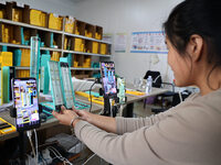 A worker works in a workshop of a fishing tackle company in Binzhou, China, on September 29, 2024. (