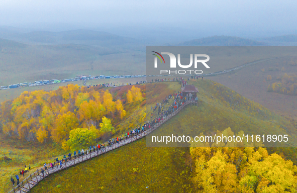 Tourists view the autumn scenery at Ulan Butong scenic spot in Chifeng, China, on September 27, 2024. 