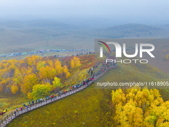 Tourists view the autumn scenery at Ulan Butong scenic spot in Chifeng, China, on September 27, 2024. (