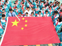 A prosecutor explains national flag knowledge to children at Qianhe Primary School in Situi Town, Guanyun County, Lianyungang City, Jiangsu...