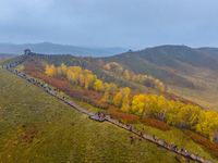 Tourists view the autumn scenery at Ulan Butong scenic spot in Chifeng, China, on September 27, 2024. (