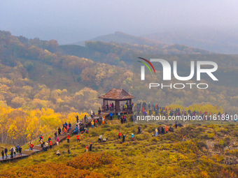 Tourists view the autumn scenery at Ulan Butong scenic spot in Chifeng, China, on September 27, 2024. (