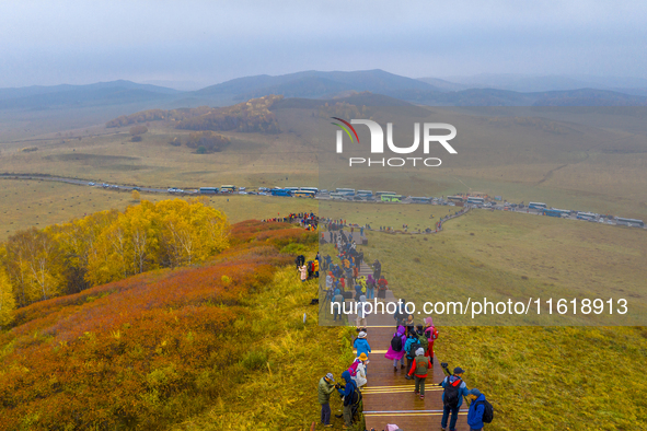 Tourists view the autumn scenery at Ulan Butong scenic spot in Chifeng, China, on September 27, 2024. 