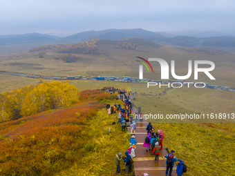 Tourists view the autumn scenery at Ulan Butong scenic spot in Chifeng, China, on September 27, 2024. (