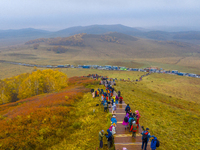 Tourists view the autumn scenery at Ulan Butong scenic spot in Chifeng, China, on September 27, 2024. (