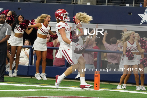 Arkansas Razorbacks wide receiver Isaac TeSlaa #4 catches a pass for a touchdown during the Southwest Classic match between the Arkansas Raz...