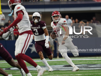 Arkansas Razorbacks punter Devin Bale #37 runs the ball against Texas A&M Aggies during the Southwest Classic match between the Arkansas Raz...