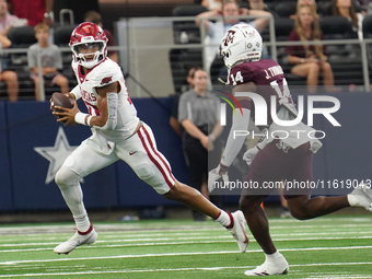 Arkansas Razorbacks quarterback Taylen Green #10 looks for an open receiver to throw the ball to while under pressure by Texas A&M defensive...