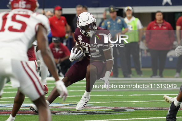 Texas A&M Aggies running back EJ Smith #22 runs the ball against the Arkansas Razorbacks during the Southwest Classic match between the Arka...