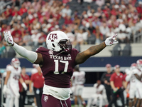 Texas A&M Aggies defensive lineman Albert Regis #17 celebrates against the Arkansas Razorbacks during the Southwest Classic match between th...