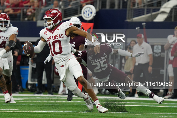 Arkansas Razorbacks quarterback Taylen Green #10 rushes out of the pocket against Texas A&M Aggies during the Southwest Classic match betwee...