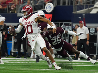 Arkansas Razorbacks quarterback Taylen Green #10 rushes out of the pocket against Texas A&M Aggies during the Southwest Classic match betwee...