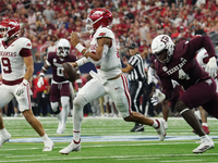 Arkansas Razorbacks quarterback Taylen Green #10 rushes out of the pocket against Texas A&M Aggies during the Southwest Classic match betwee...