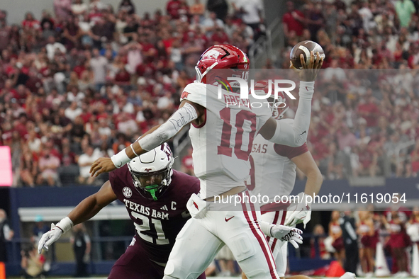 Arkansas Razorbacks quarterback Taylen Green #10 rolls out of the pocket and throws the ball against Texas A&M Aggies during the Southwest C...