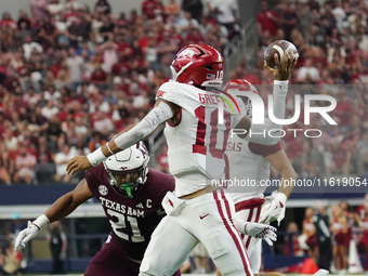 Arkansas Razorbacks quarterback Taylen Green #10 rolls out of the pocket and throws the ball against Texas A&M Aggies during the Southwest C...