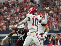 Arkansas Razorbacks quarterback Taylen Green #10 rolls out of the pocket and throws the ball against Texas A&M Aggies during the Southwest C...