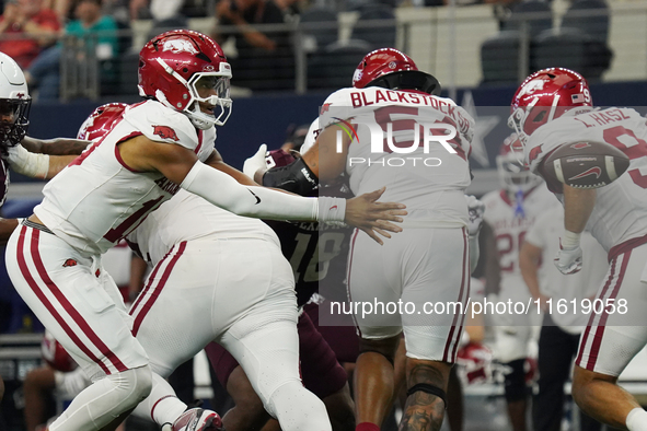 Arkansas Razorbacks quarterback Taylen Green #10 pitches the ball against Texas A&M Aggies during the Southwest Classic match between the Ar...