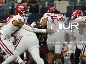 Arkansas Razorbacks quarterback Taylen Green #10 pitches the ball against Texas A&M Aggies during the Southwest Classic match between the Ar...