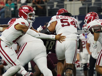 Arkansas Razorbacks quarterback Taylen Green #10 pitches the ball against Texas A&M Aggies during the Southwest Classic match between the Ar...