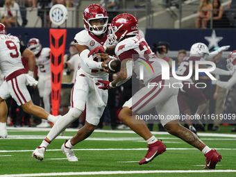 Arkansas Razorbacks quarterback Taylen Green #10 hands off to Arkansas Razorbacks running back Ja'Quinden Jackson #22 during a play against...