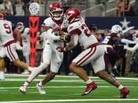 Arkansas Razorbacks quarterback Taylen Green #10 hands off to Arkansas Razorbacks running back Ja'Quinden Jackson #22 during a play against...