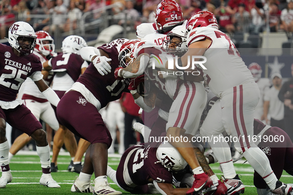 Arkansas Razorbacks running back Ja'Quinden Jackson #22 is tackled by the Texas A&M Aggies defense during the Southwest Classic match betwee...