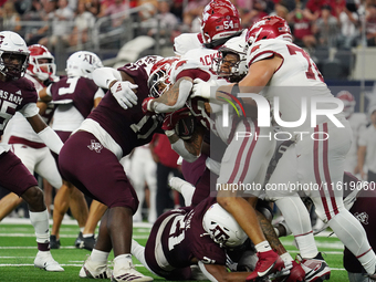 Arkansas Razorbacks running back Ja'Quinden Jackson #22 is tackled by the Texas A&M Aggies defense during the Southwest Classic match betwee...