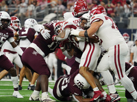 Arkansas Razorbacks running back Ja'Quinden Jackson #22 is tackled by the Texas A&M Aggies defense during the Southwest Classic match betwee...