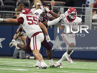 Arkansas Razorbacks running back Braylen Russell #0 runs with the ball as he eludes Texas A&M Aggies Albert Regis #17 for a yard gain during...