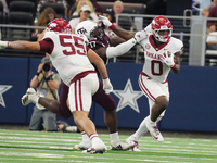 Arkansas Razorbacks running back Braylen Russell #0 runs with the ball as he eludes Texas A&M Aggies Albert Regis #17 for a yard gain during...