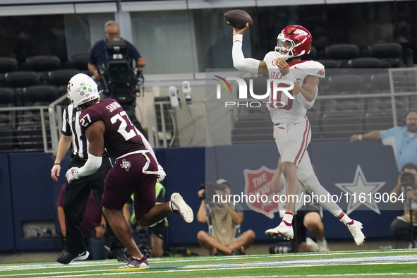 Arkansas Razorbacks quarterback Taylen Green #10 jumps while passing the ball against the Texas A&M Aggies during the Southwest Classic matc...