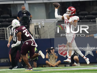 Arkansas Razorbacks quarterback Taylen Green #10 jumps while passing the ball against the Texas A&M Aggies during the Southwest Classic matc...