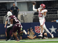 Arkansas Razorbacks quarterback Taylen Green #10 jumps while passing the ball against the Texas A&M Aggies during the Southwest Classic matc...