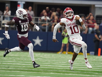 Arkansas Razorbacks quarterback Taylen Green #10 runs for positive yardage against the Texas A&M Aggies during the Southwest Classic match b...