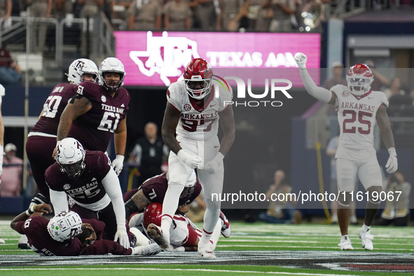 Arkansas Razorbacks defensive lineman Quincy Rhodes Jr. #97 celebrates after making a tackle for loss of yardage against Texas A&M Aggies qu...