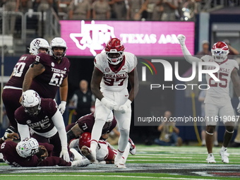 Arkansas Razorbacks defensive lineman Quincy Rhodes Jr. #97 celebrates after making a tackle for loss of yardage against Texas A&M Aggies qu...