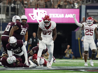 Arkansas Razorbacks defensive lineman Quincy Rhodes Jr. #97 celebrates after making a tackle for loss of yardage against Texas A&M Aggies qu...