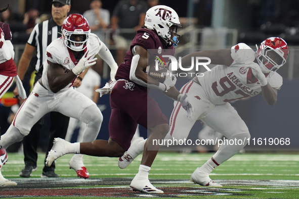 Texas A&M Aggies running back Amari Daniels #5 rushes with the ball against the Arkansas Razorbacks during the Southwest Classic match betwe...