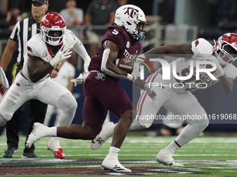 Texas A&M Aggies running back Amari Daniels #5 rushes with the ball against the Arkansas Razorbacks during the Southwest Classic match betwe...