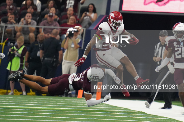 Arkansas Razorbacks running back Ja'Quinden Jackson #22 avoids a tackle by Texas A&M Aggies defensive back Marcus Ratcliffe #3 during the So...