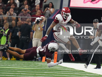 Arkansas Razorbacks running back Ja'Quinden Jackson #22 avoids a tackle by Texas A&M Aggies defensive back Marcus Ratcliffe #3 during the So...