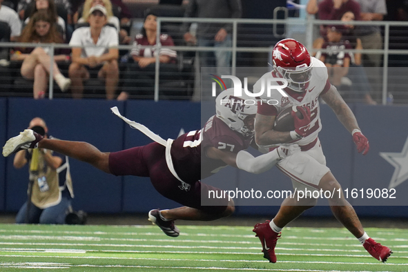 Arkansas Razorbacks running back Ja'Quinden Jackson #22 is tackled by Texas A&M Aggies linebacker Daymion Sanford #27 during the Southwest C...