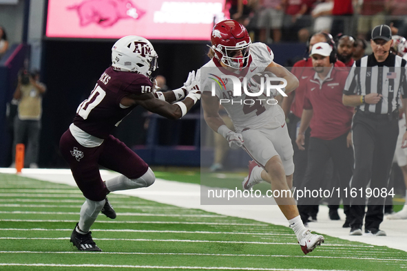 Arkansas Razorbacks wide receiver Isaac TeSlaa #4 rushes with the ball against the Texas A&M Aggies during the Southwest Classic match betwe...